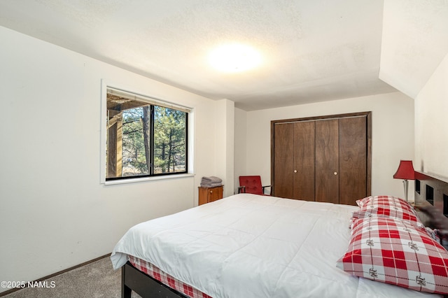 bedroom featuring a closet, a textured ceiling, and carpet flooring