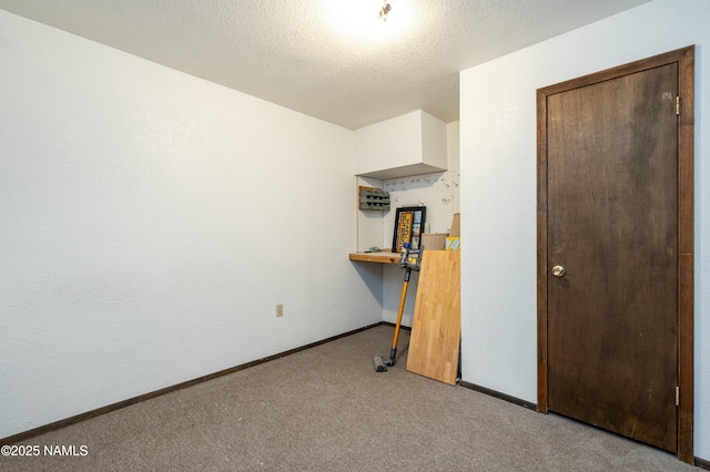 unfurnished bedroom with light carpet and a textured ceiling