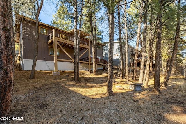 rear view of house featuring a wooden deck