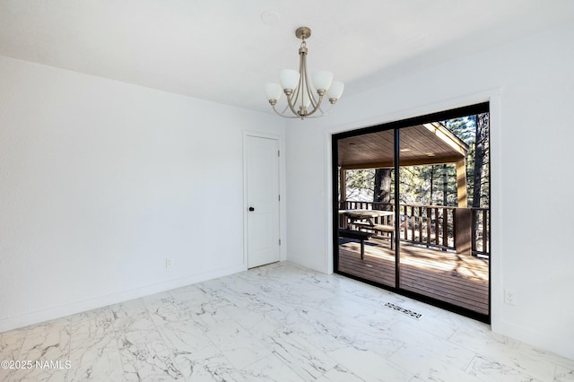 unfurnished room with an inviting chandelier