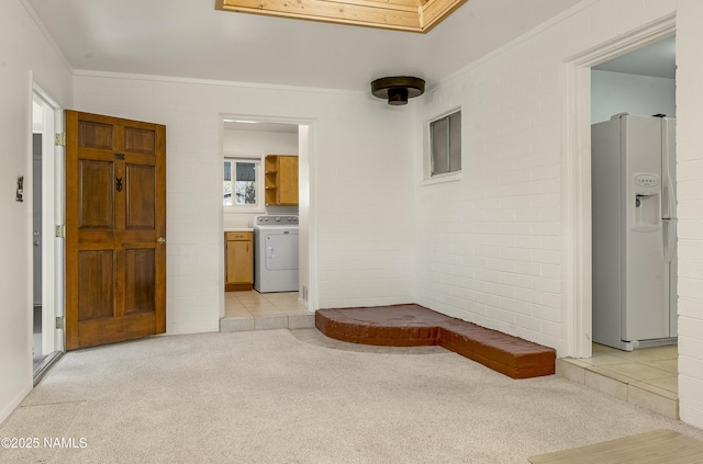 1907 N Meadow Lark Dr, Flagstaff, AZ 86001 - corridor with light tile patterned floors, washer / clothes dryer, brick wall, and light colored carpet