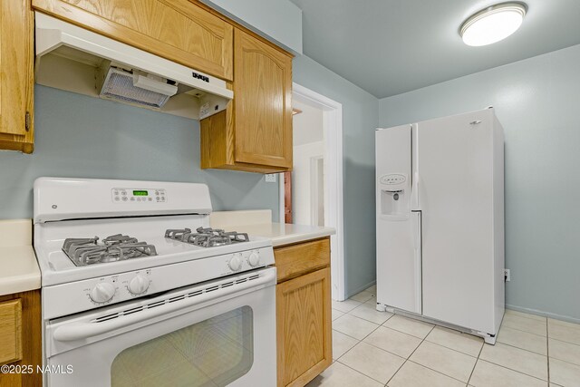 1907 N Meadow Lark Dr, Flagstaff, AZ 86001 - kitchen with white appliances, light countertops, under cabinet range hood, and light tile patterned floors