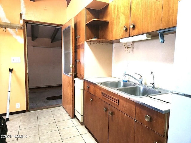 kitchen with light tile patterned floors and a sink