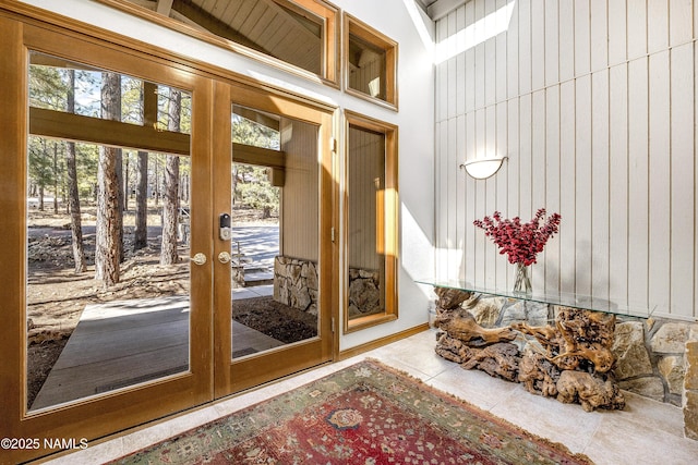 doorway to outside featuring light tile patterned floors, french doors, and a healthy amount of sunlight