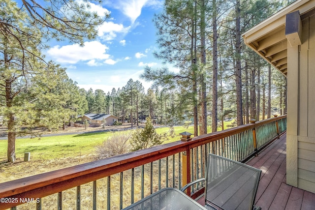 wooden deck featuring a yard