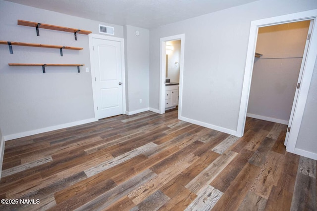 73 Seneca Dr, Flagstaff, AZ 86005 - unfurnished bedroom featuring wood finished floors, baseboards, and visible vents