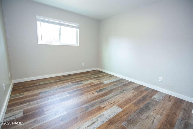 73 Seneca Dr, Flagstaff, AZ 86005 - empty room featuring baseboards and wood finished floors