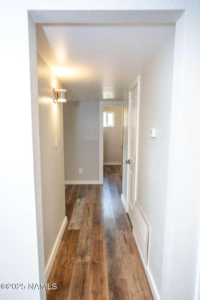 73 Seneca Dr, Flagstaff, AZ 86005 - corridor with baseboards, visible vents, and wood finished floors