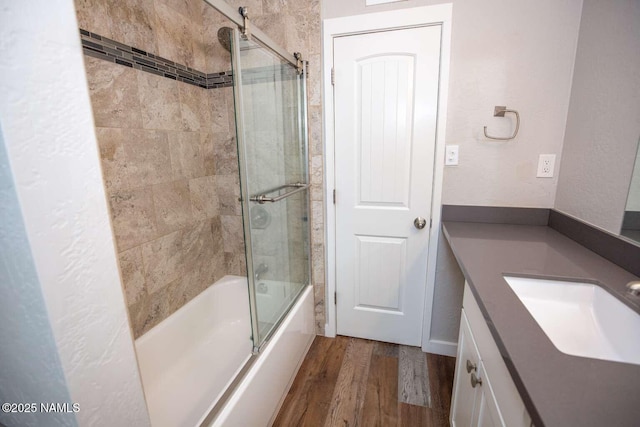 73 Seneca Dr, Flagstaff, AZ 86005 - full bath featuring a textured wall, wood finished floors, shower / bath combination with glass door, and vanity