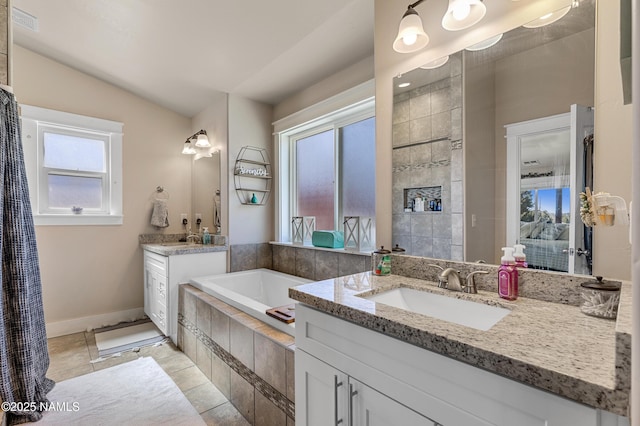 bathroom with a relaxing tiled tub, tile patterned floors, vanity, and vaulted ceiling