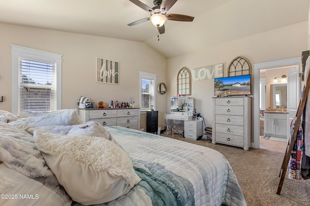 bedroom with lofted ceiling, light carpet, ceiling fan, and ensuite bathroom