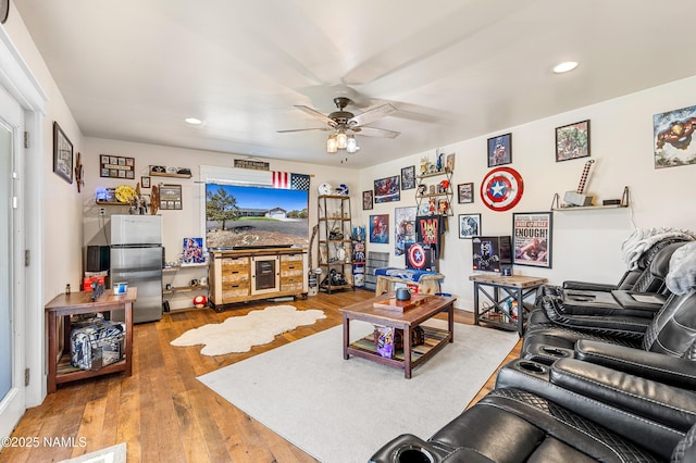 living room with wood-type flooring and ceiling fan