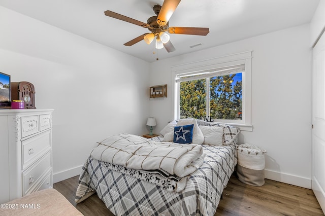 bedroom featuring dark hardwood / wood-style flooring and ceiling fan