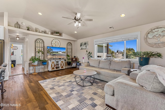 living room with dark wood-type flooring, ceiling fan, and lofted ceiling