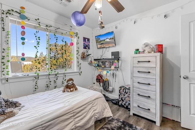 bedroom with hardwood / wood-style floors and ceiling fan