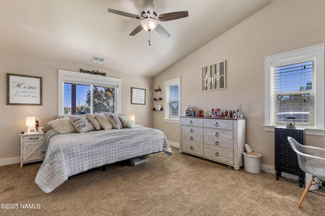 bedroom featuring multiple windows, vaulted ceiling, and light colored carpet