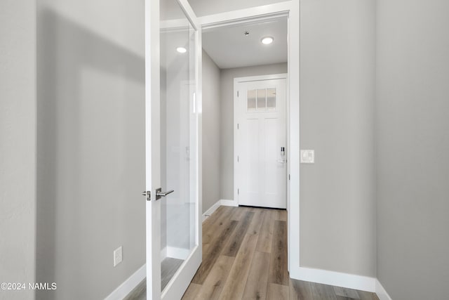 hallway with light hardwood / wood-style flooring