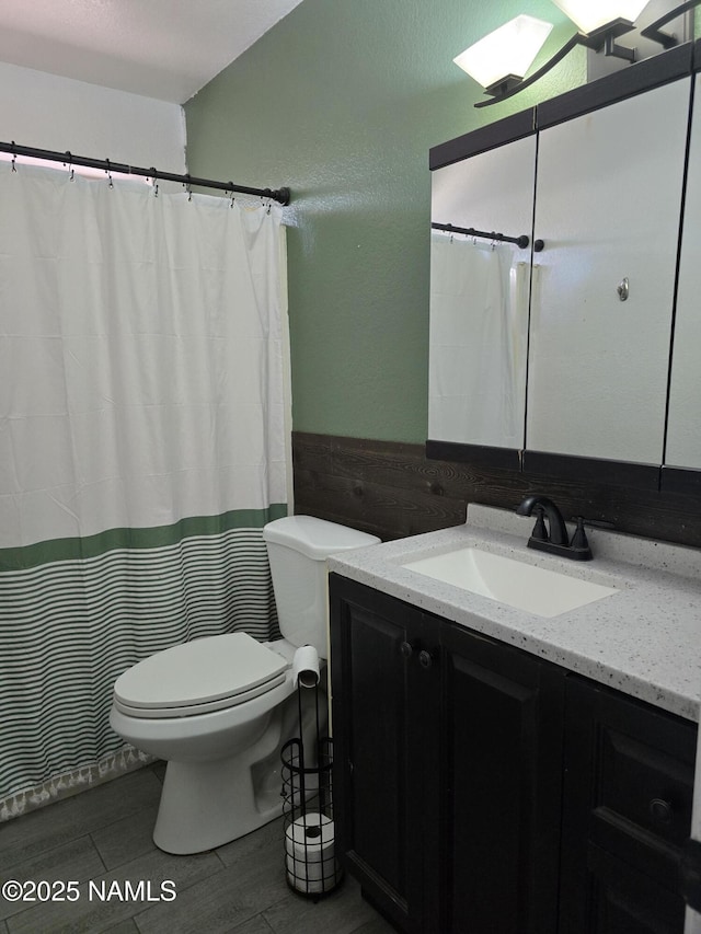 5895 Timberline Trl, Flagstaff, AZ 86004 - full bathroom featuring toilet, wainscoting, wood finished floors, and vanity