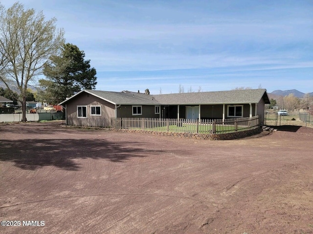 single story home with driveway and a fenced front yard