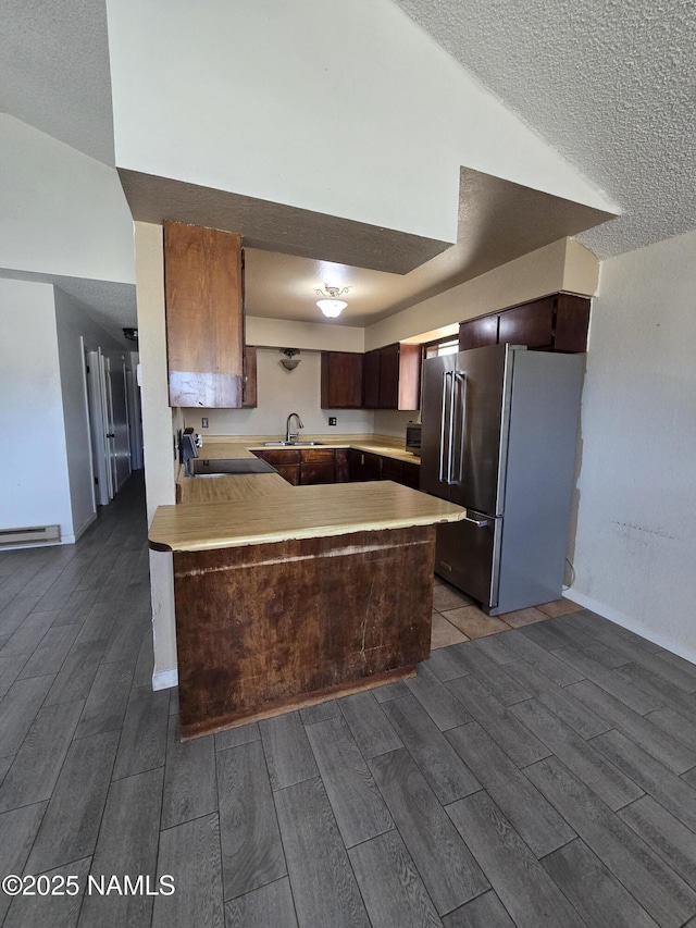 5895 Timberline Trl, Flagstaff, AZ 86004 - kitchen featuring light countertops, a peninsula, high end refrigerator, and wood tiled floor