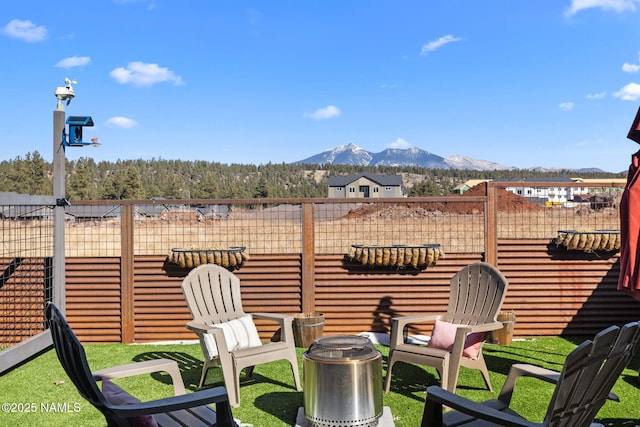 view of yard featuring fence and a mountain view