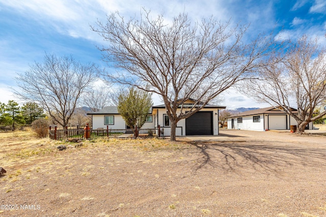 8400 Pine Country Ln, Flagstaff, AZ 86004 - single story home with dirt driveway, fence, and an attached garage