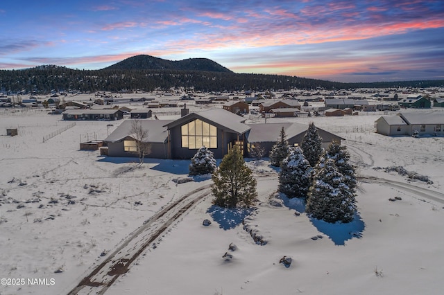 snowy aerial view featuring a mountain view