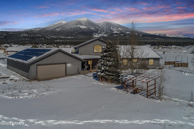 chalet / cabin with a mountain view and an attached garage