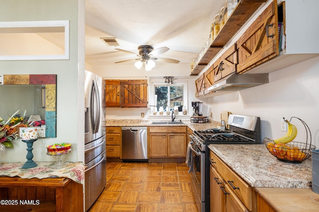 kitchen with visible vents, ceiling fan, under cabinet range hood, brown cabinetry, and stainless steel appliances