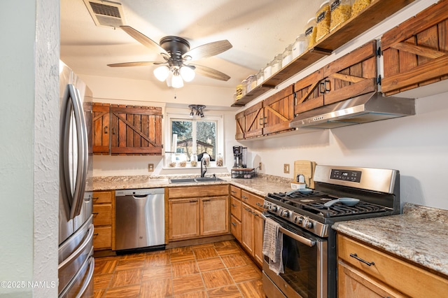 kitchen featuring visible vents, a sink, under cabinet range hood, stainless steel appliances, and ceiling fan