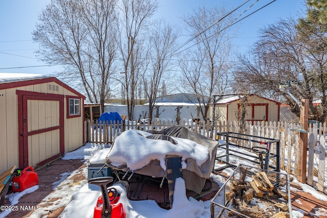 exterior space featuring a storage shed, an outdoor structure, and fence