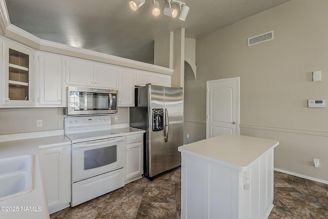 18525 N 85th Ave, Peoria, AZ 85382 - kitchen featuring appliances with stainless steel finishes, white cabinets, arched walkways, and light countertops