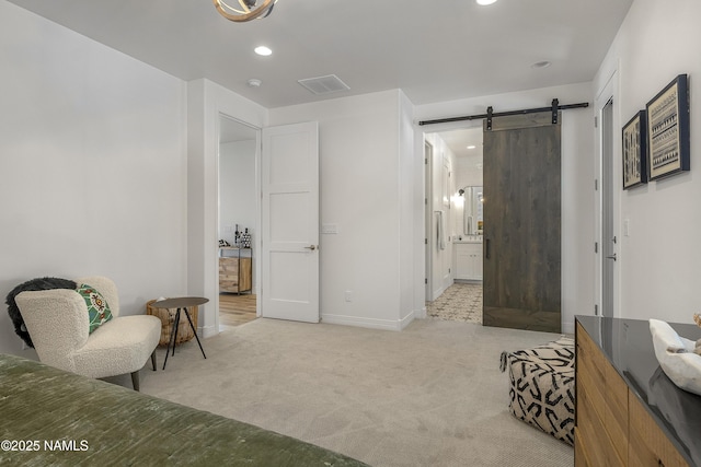 sitting room with visible vents, baseboards, light colored carpet, a barn door, and recessed lighting