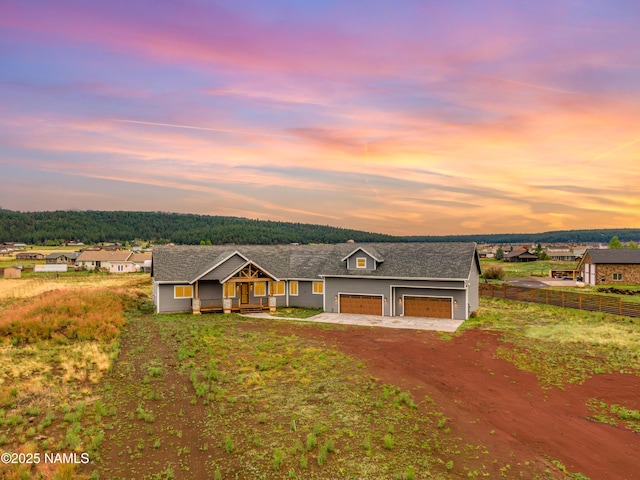 7497 W Dreamview Trl, Flagstaff, AZ 86001 - ranch-style home featuring dirt driveway, a porch, and an attached garage