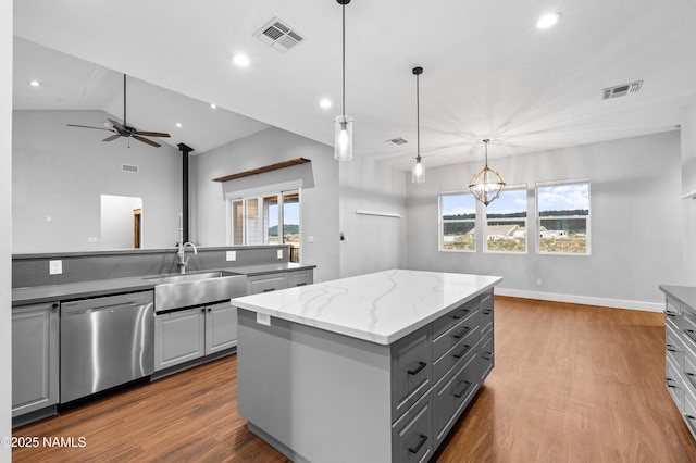 7497 W Dreamview Trl, Flagstaff, AZ 86001 - kitchen with stainless steel dishwasher, gray cabinetry, a sink, wood finished floors, and recessed lighting