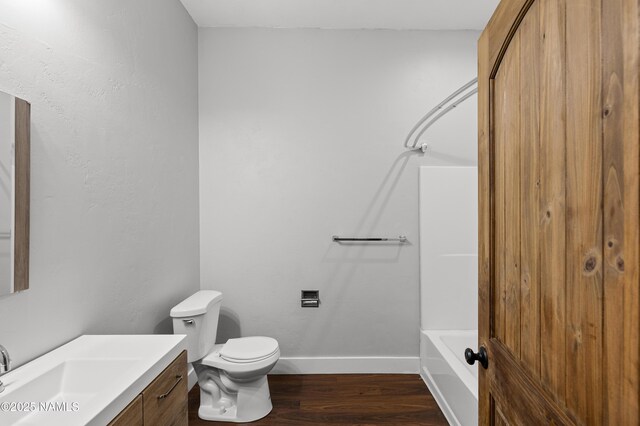 7497 W Dreamview Trl, Flagstaff, AZ 86001 - bathroom with vanity, wood finished floors, toilet, bathing tub / shower combination, and baseboards
