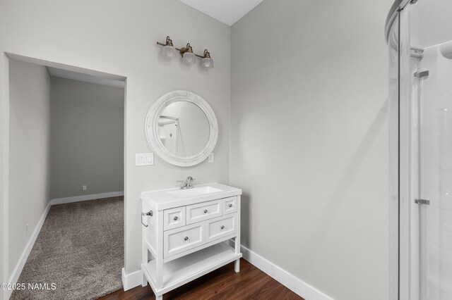 7497 W Dreamview Trl, Flagstaff, AZ 86001 - bathroom with vanity, baseboards, and wood finished floors