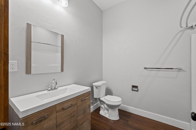 7497 W Dreamview Trl, Flagstaff, AZ 86001 - bathroom featuring vanity, wood finished floors, baseboards, and toilet