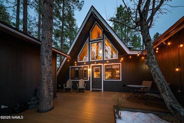 rear view of house featuring a deck