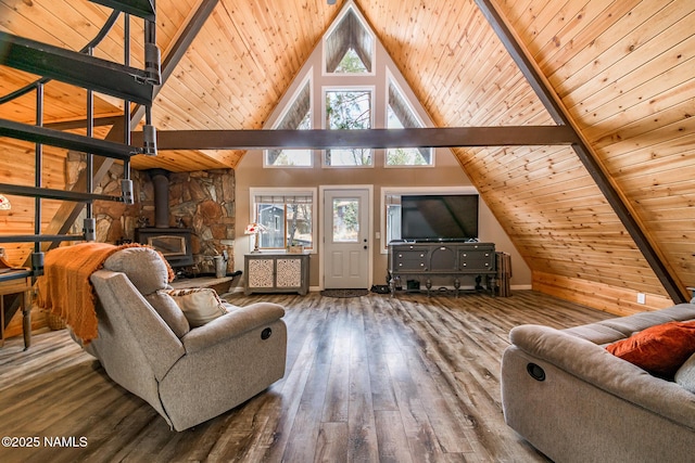 living area featuring wood ceiling, a wood stove, and wood finished floors