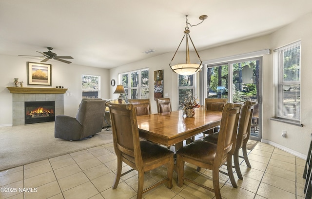 2545 N Broken Circle Rd, Flagstaff, AZ 86004 - dining space featuring light tile patterned floors, baseboards, a fireplace, ceiling fan, and light carpet
