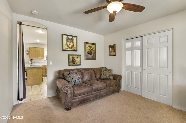2545 N Broken Circle Rd, Flagstaff, AZ 86004 - living room featuring light colored carpet, ceiling fan, and baseboards
