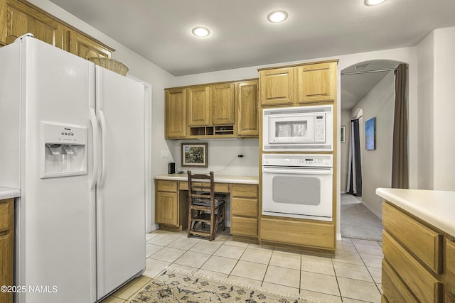 2545 N Broken Circle Rd, Flagstaff, AZ 86004 - kitchen with white appliances, light countertops, light tile patterned floors, recessed lighting, and brown cabinetry