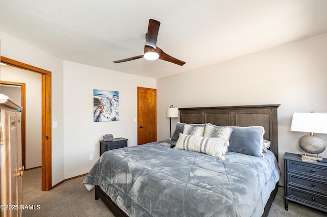 bedroom with a ceiling fan, baseboards, and light carpet