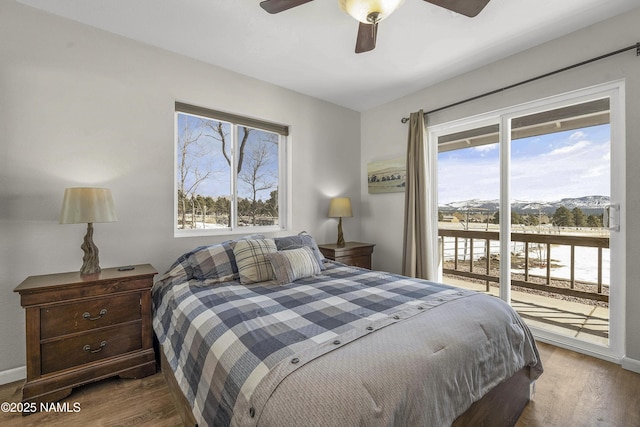 bedroom featuring access to exterior, baseboards, a ceiling fan, and wood finished floors