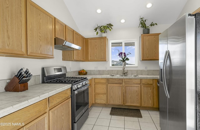 kitchen featuring light tile patterned floors, recessed lighting, a sink, stainless steel appliances, and under cabinet range hood