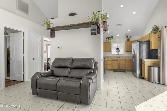 living room featuring light tile patterned floors, visible vents, recessed lighting, and high vaulted ceiling