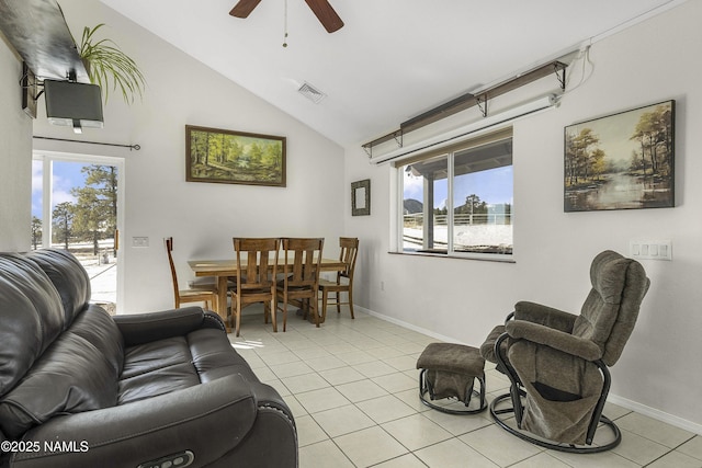 living area featuring visible vents, lofted ceiling, baseboards, and tile patterned flooring