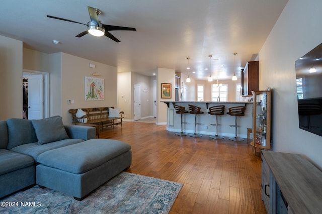 living room with ceiling fan and light hardwood / wood-style floors