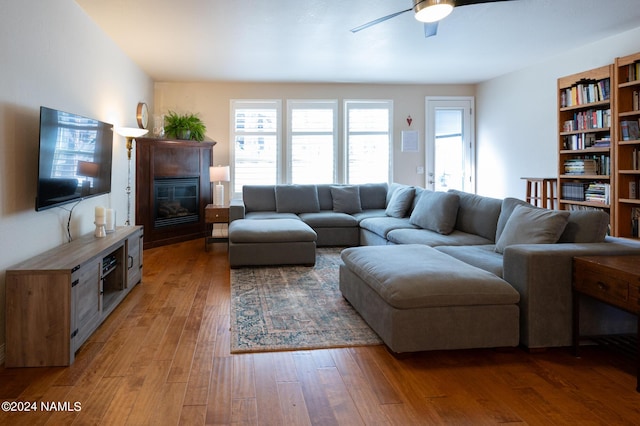 living room featuring hardwood / wood-style flooring and ceiling fan